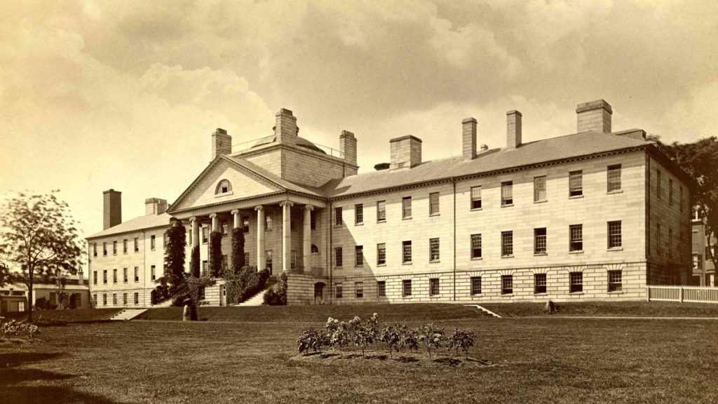 Three-storied portico granite building with two sets of stone stairs, one dome