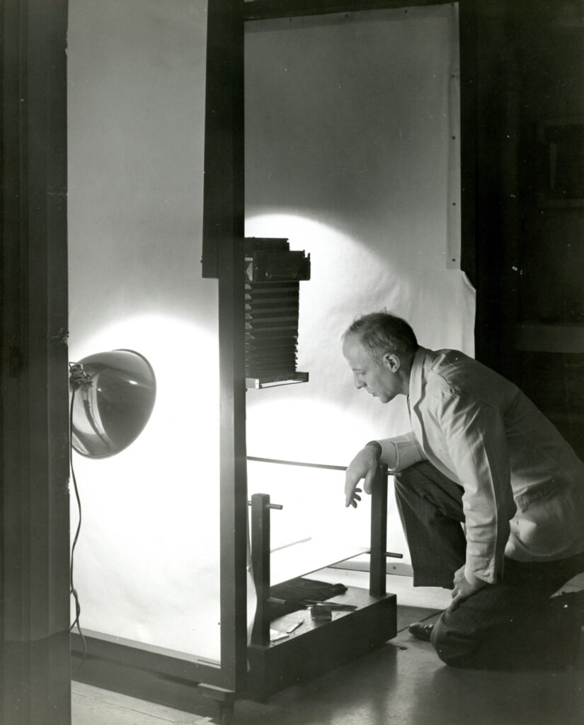 Man kneeling over photo studio set-up