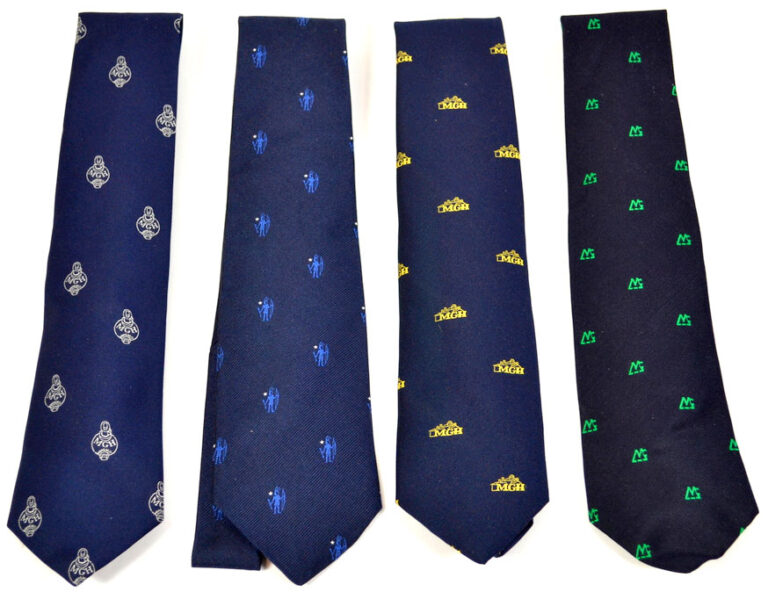 Four navy-colored ties, each with different designs embroidered in different colors