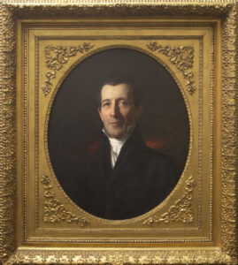 Oil painting in late gold rectangular frame with oval cut-out