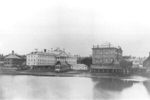 black and white photo of three buildings on the wars egg. "A Photographic Album: Massachusetts General Hospital" is superimposed on the top