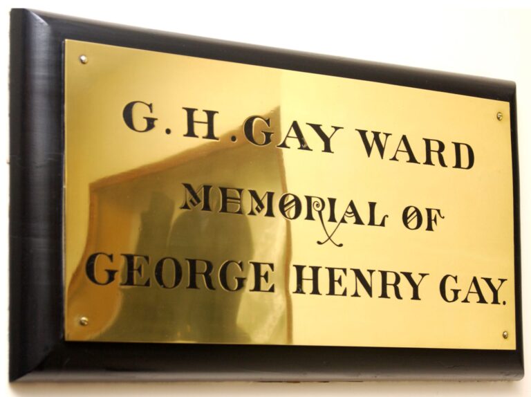 Brass plaque is engraved with the words "G. H. GAY WARD MEMORIAL OF GEORGE HENRY GAY."
