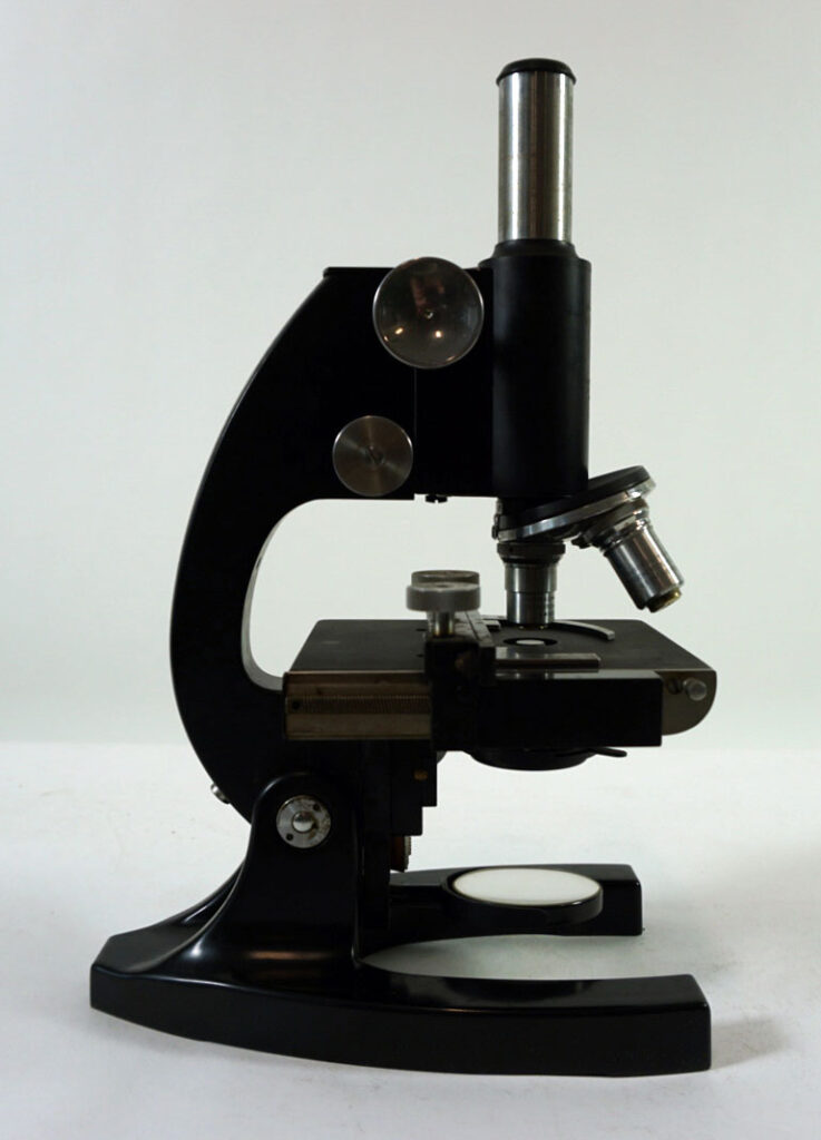 color photo of small black microscope in profile