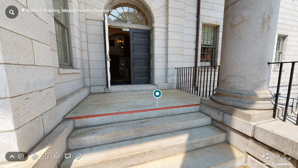 Screenshot of staircase leading from the Bulfinch Lawn to the Bulfinch Building, the top step is painted with a red line across its length